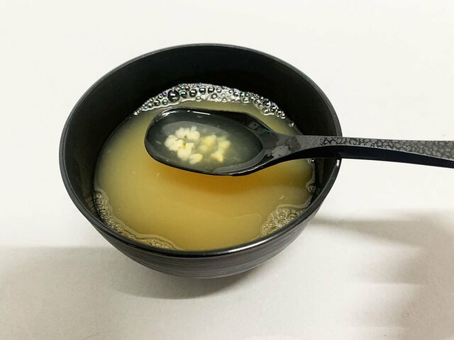 『カニ鍋スープ雑炊仕立て』の中身を撮影した画像。スプーンにお米が浮いている。（撮影／編集部）