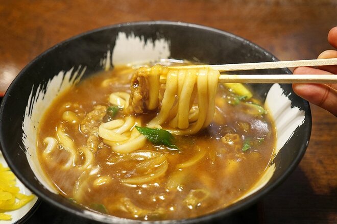 熱々のカレーうどんを箸で持ち上げる画像　(画像はphotoACより)