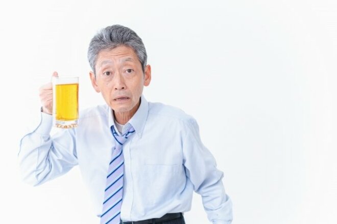 ビールを掲げるサラリーマンの姿（画像はphotoACより）